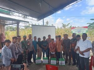 Kapolres Lutim AKBP Zulkarnain memberikan tali asih kepada lansia dan disabilitas usai panen raya jagung di Kecamatan Wotu, Kamis, (05/2/06/25)