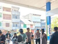 Polwan Satlantas Polres Pelabuhan Makassar bagikan air minum ke warga antre BBM